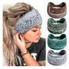 A woman shows off several brown, green, and gray boho print cotton headbands for hair and workout.