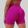 A close-up shot of a woman wearing bright magenta seamless high-waist yoga leggings.