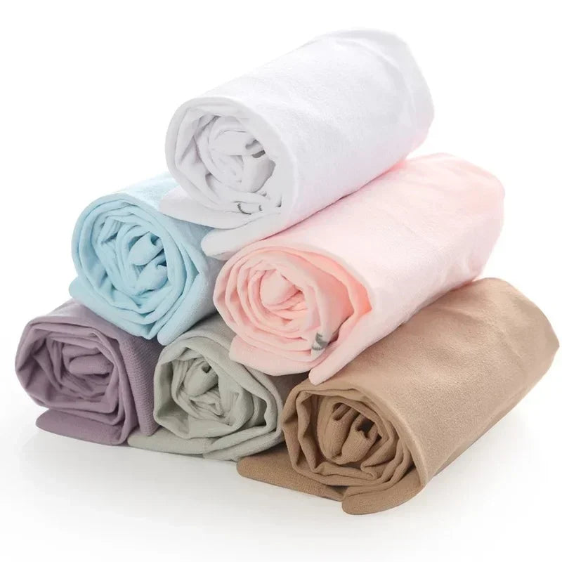 A stack of rolled ice sleeves in various pastel colors including white, light blue, pink, and beige.