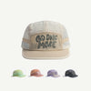 A beige baseball cap with gray text that reads GO ONE MORE, shown in various colors.