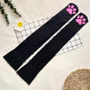 Black thigh high socks with pink cat paw prints displayed on a white grid background.