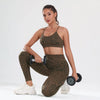 A woman models a leopard print seamless two-piece sports set consisting of a crop top and leggings.
