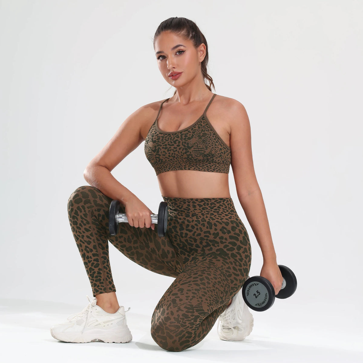 A woman models a leopard print seamless two-piece sports set consisting of a crop top and leggings.