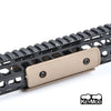 A close-up view of a tactical rail panel kit for airsoft guns featuring a beige mounting plate and black rails.