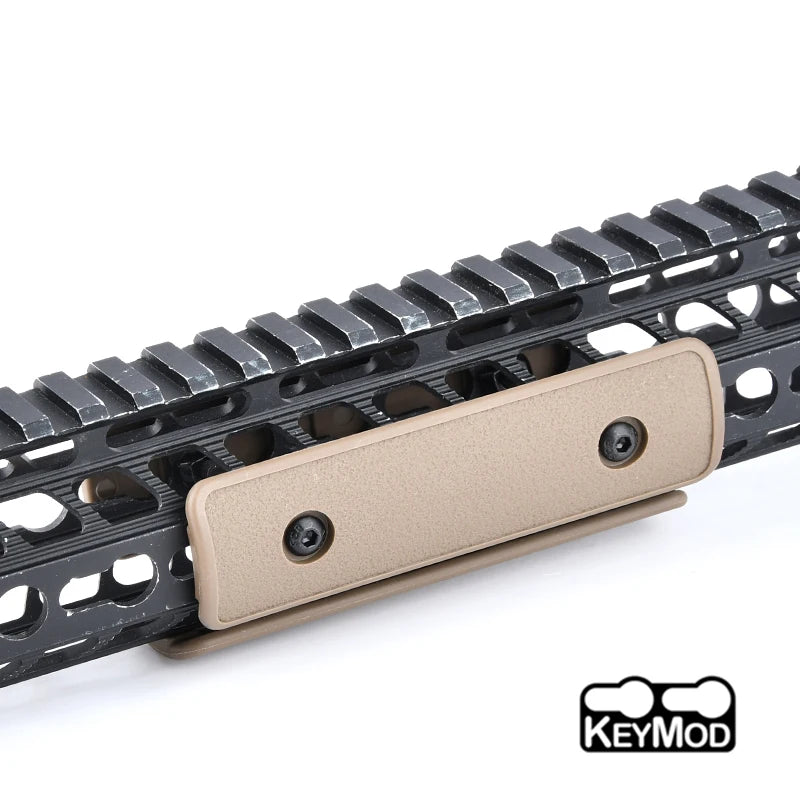 A close-up view of a tactical rail panel kit for airsoft guns featuring a beige mounting plate and black rails.