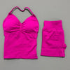 A bright pink women's seamless backless fitness set consisting of a cropped top and long-sleeved leggings.