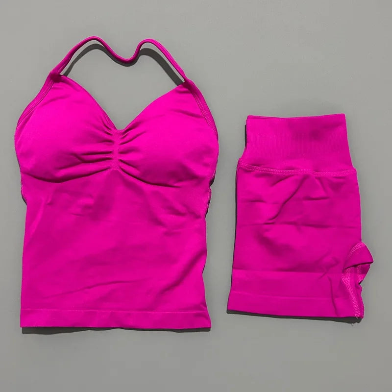 A bright pink women's seamless backless fitness set consisting of a cropped top and long-sleeved leggings.