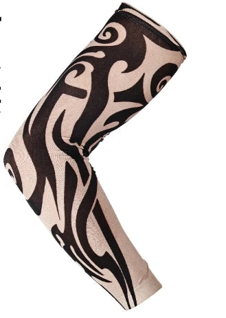 A close-up of a long seamless tattoo sleeve in black and beige swirling patterns.