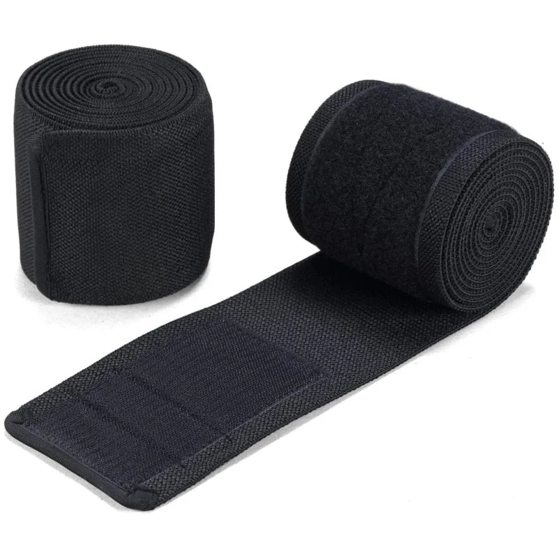 Black high-performance knee wraps rolled and laid out for strength training