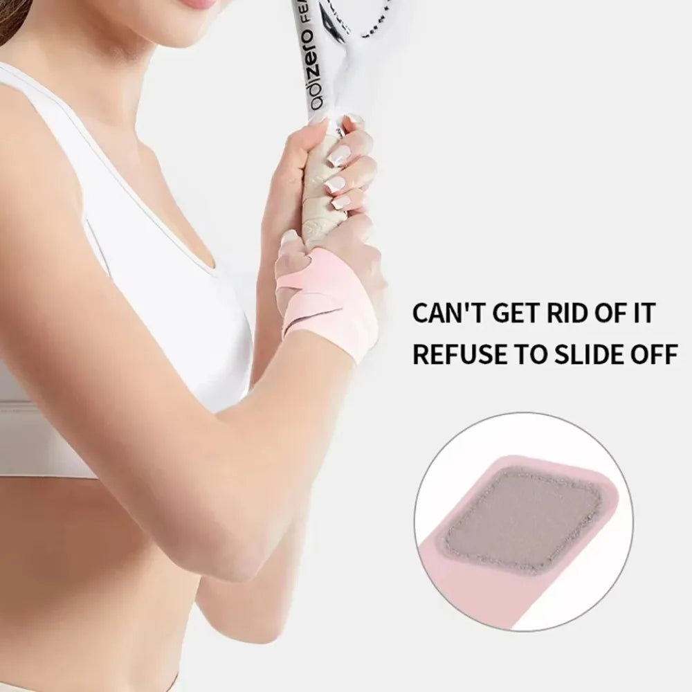 A hand is sliding off a pink breathable wrist guard for sports and fitness.
