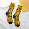 A pair of black crew socks featuring a vibrant yellow and green sunflower print.