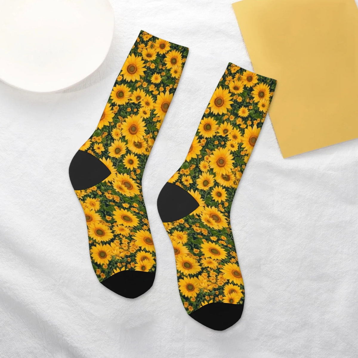 A pair of black crew socks featuring a vibrant yellow and green sunflower print.