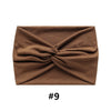 A brown fabric headband folded into a knot, shown flat.