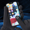 A hand wearing black cycling gloves is holding a smartphone displaying an app interface.