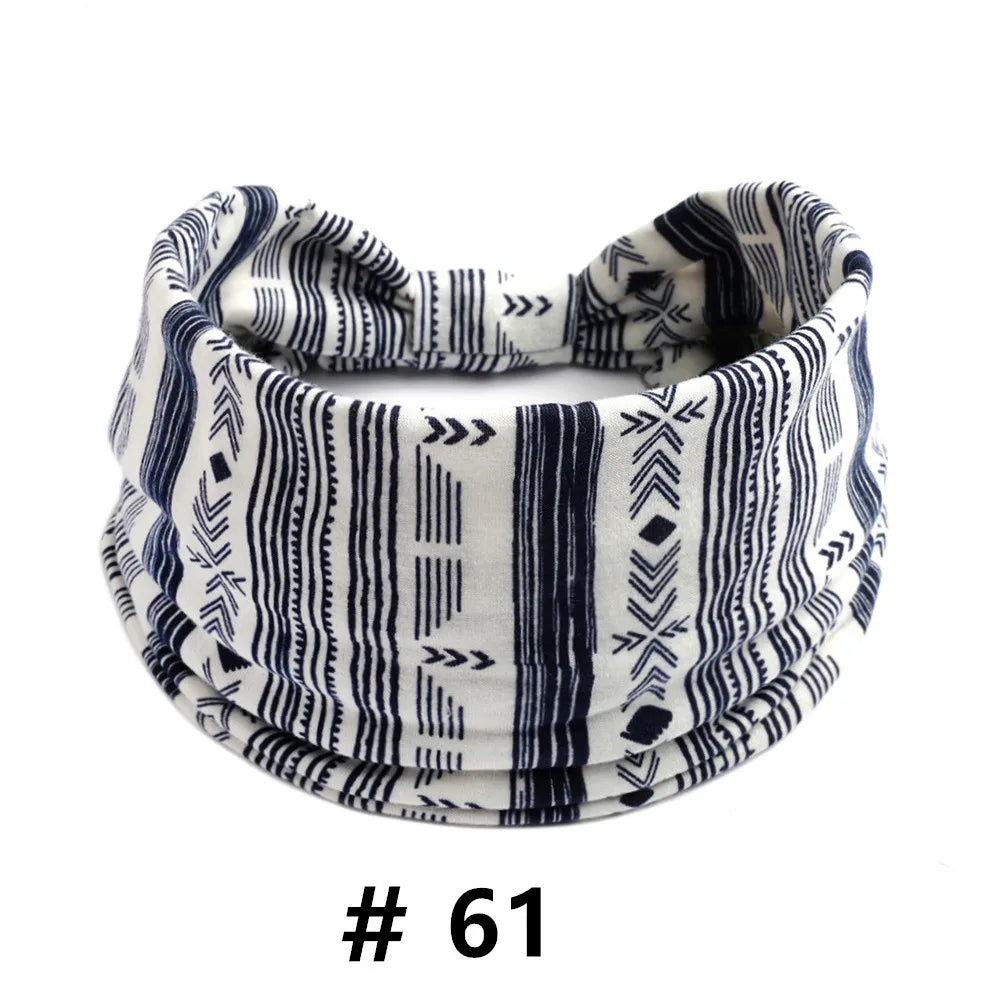 A close-up of a striped black and white boho cotton turban headband worn around the head.