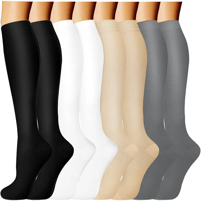 A row of compression socks in various shades of black, white, and beige are displayed vertically.