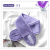 A purple exfoliating mitt is shown next to a lilac purple flower arrangement.