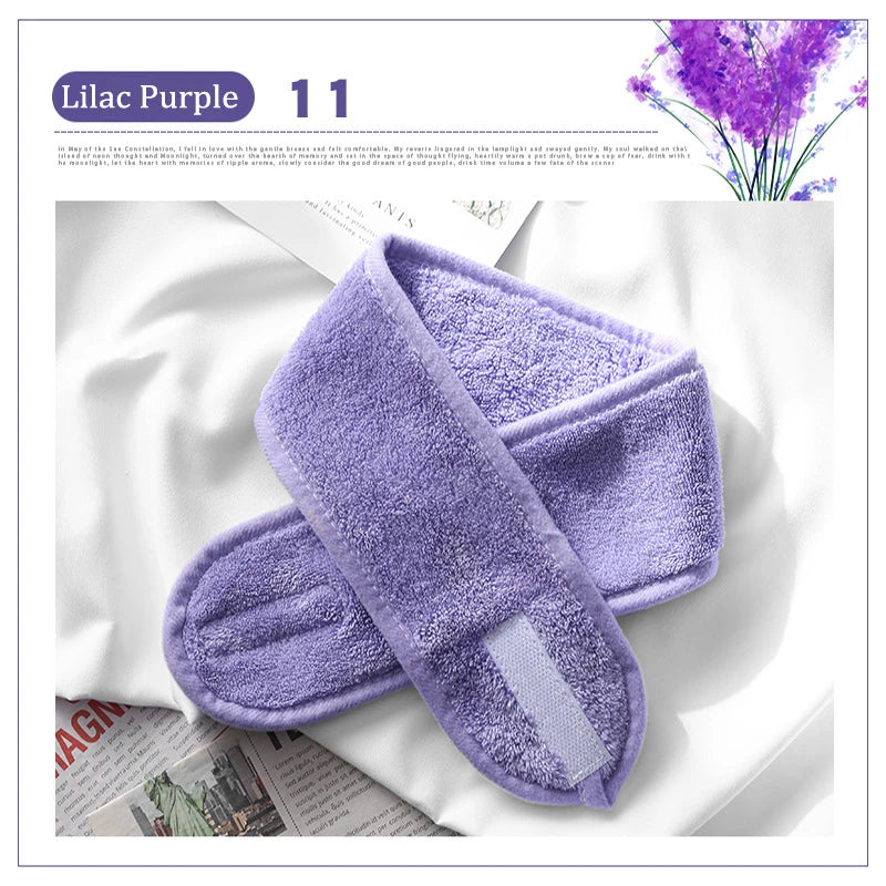 A purple exfoliating mitt is shown next to a lilac purple flower arrangement.