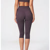 A woman models a dark plum women's premium fitness tracksuit, showing the full-length suit from the front and back.