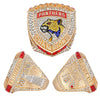 A set of gold and diamond championship rings featuring a panther motif and championship text.