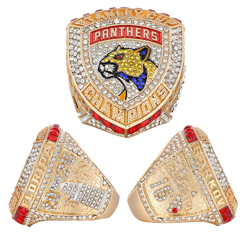 A set of gold and diamond championship rings featuring a panther motif and championship text.