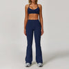 A woman models a navy blue 3-piece yoga sports set consisting of a cropped top and full-length leggings.