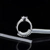 A set of four invisible ring sizer tools including a ring and a diamond ring, displayed on a reflective black surface.