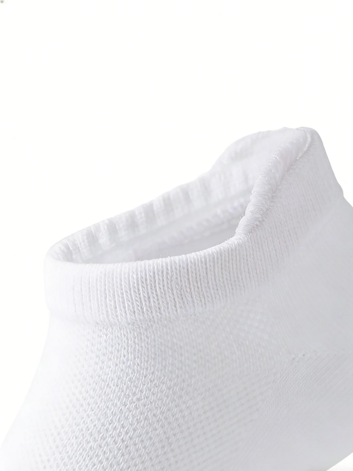 Close-up view of a white breathable ankle sock cuff.