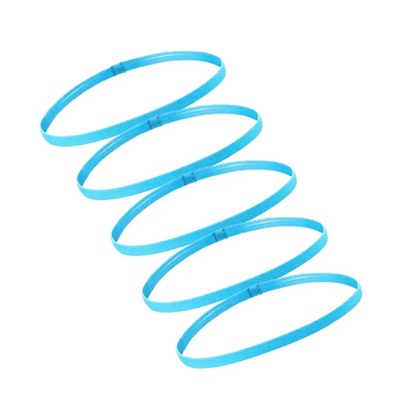A set of five bright blue elastic sports headbands coiled in a spiral pattern.