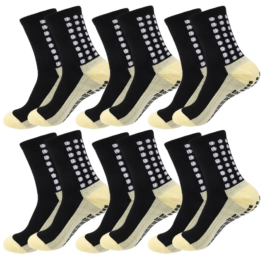 A set of black and beige non-slip grip socks for sports, shown from the side.
