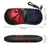 Black and red spider web patterned eyeglass pouch with a hook closure.