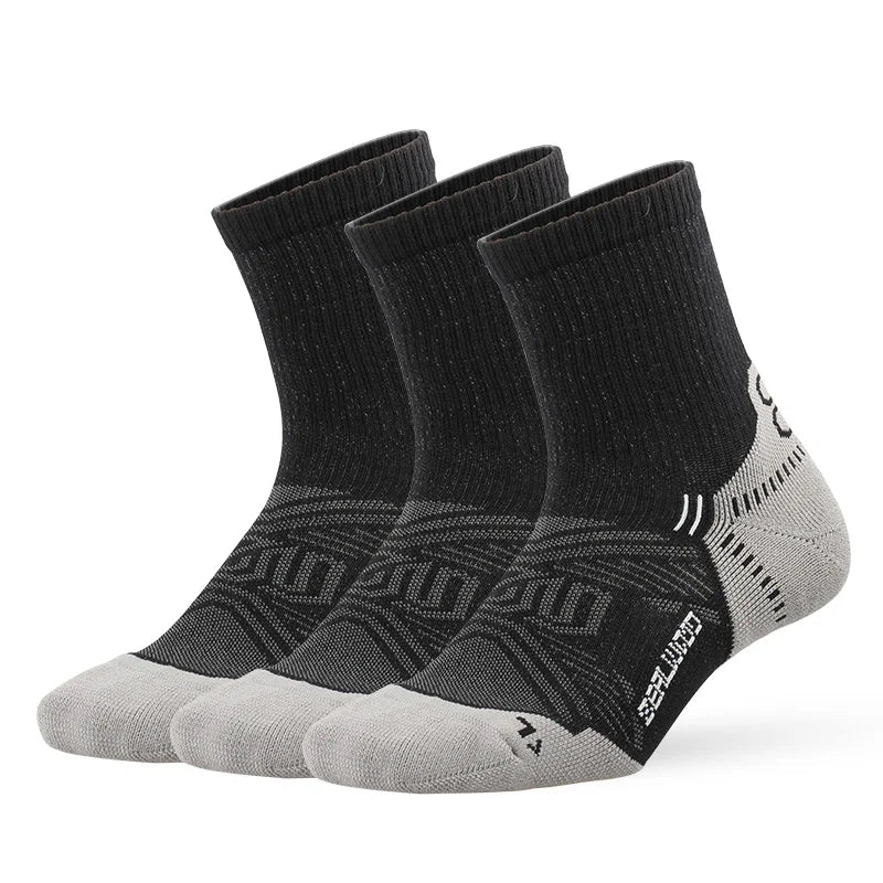 A pair of black and gray breathable performance running socks displayed flat.