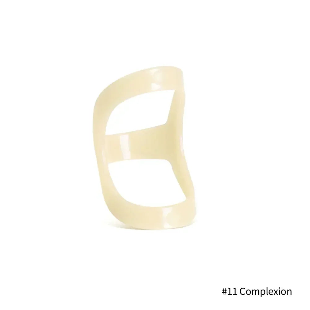 A beige ergonomic finger splint designed for joint support.