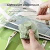 Hands hold a light green silicone folding water bottle, demonstrating its lightweight and compact design for travel.