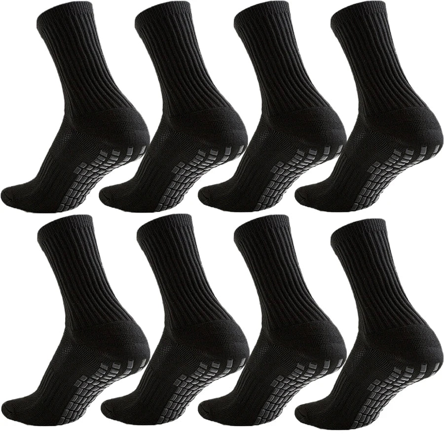 A set of black athletic grip socks shown from the side and top view.