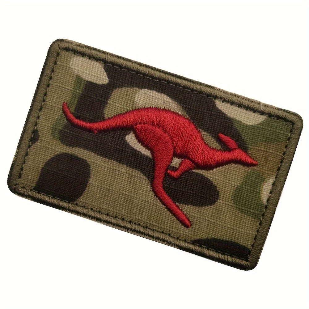 An embroidered patch featuring a red kangaroo silhouette on a camouflage background.