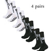 Four pairs of black men's athletic soccer socks with anti-slip grip