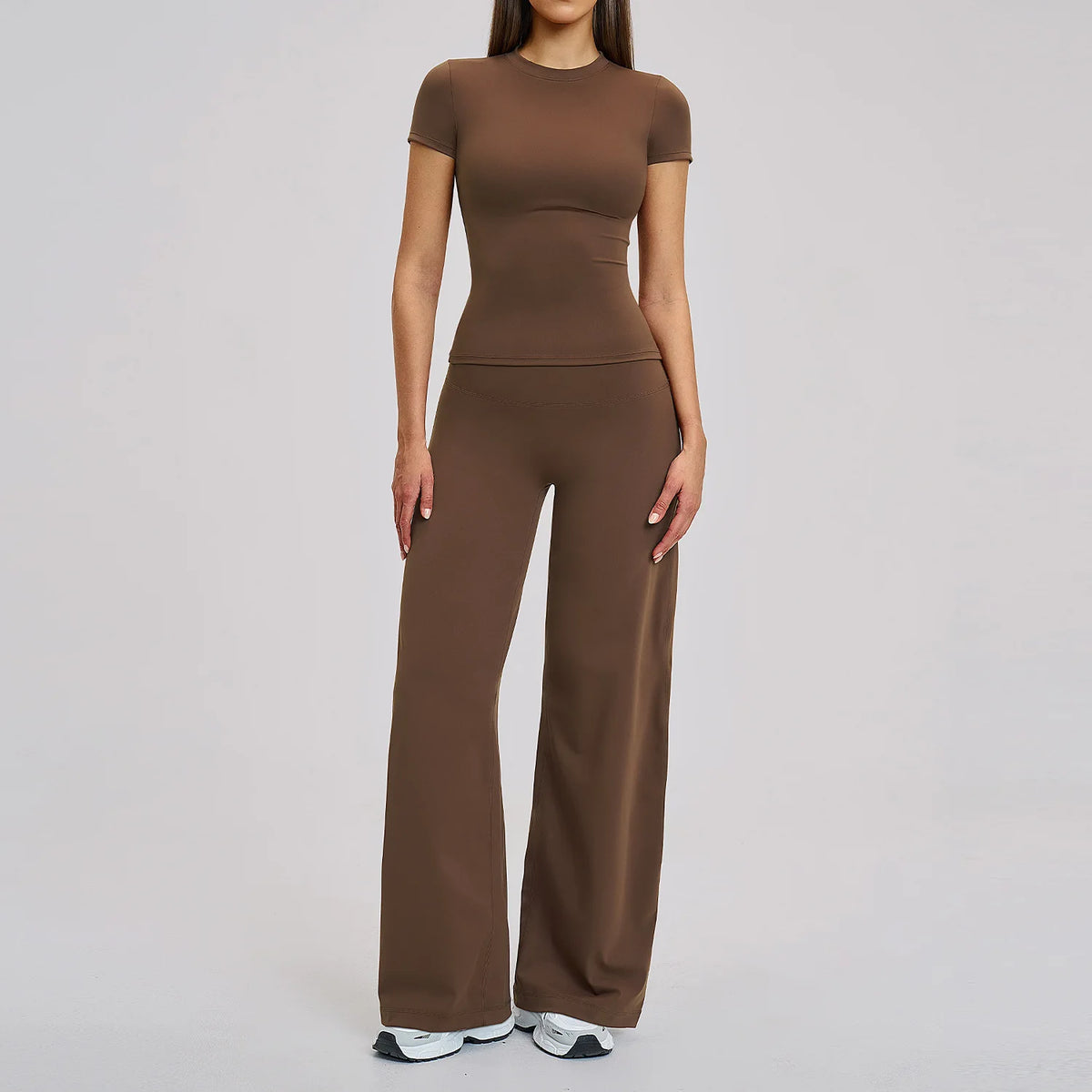 A woman wearing a matching brown high-waist yoga and gym leggings set.