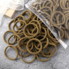 A pile of 50 pieces of mixed color elastic hair bands in a clear plastic bag on a gray surface.
