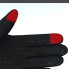 Black sports gloves with red accents shown on a hand, designed to warm hands and control a phone.