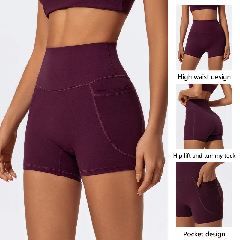 A woman models a deep purple high-waist yoga and workout short featuring a side pocket.