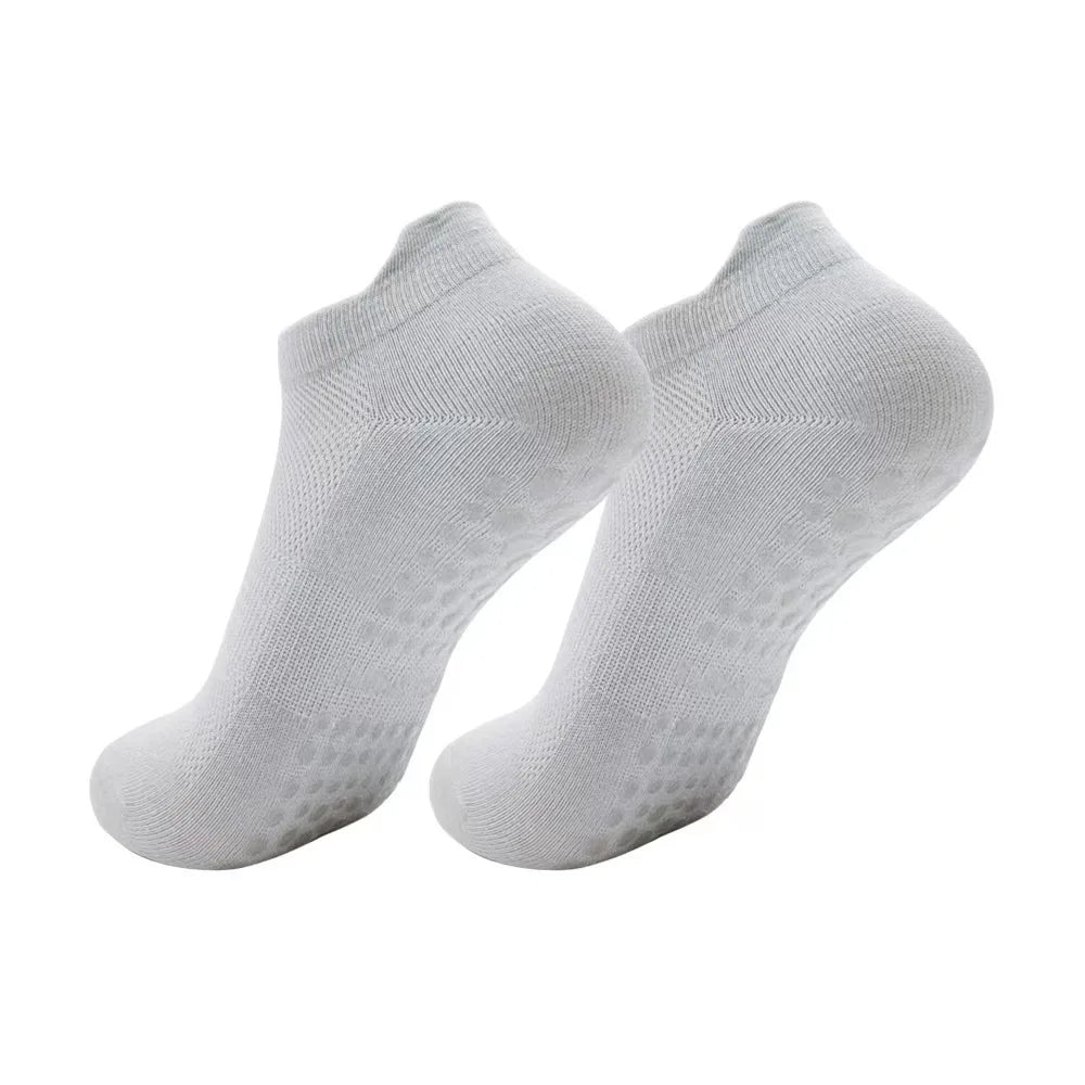 A pair of white women's yoga and fitness socks shown from above.