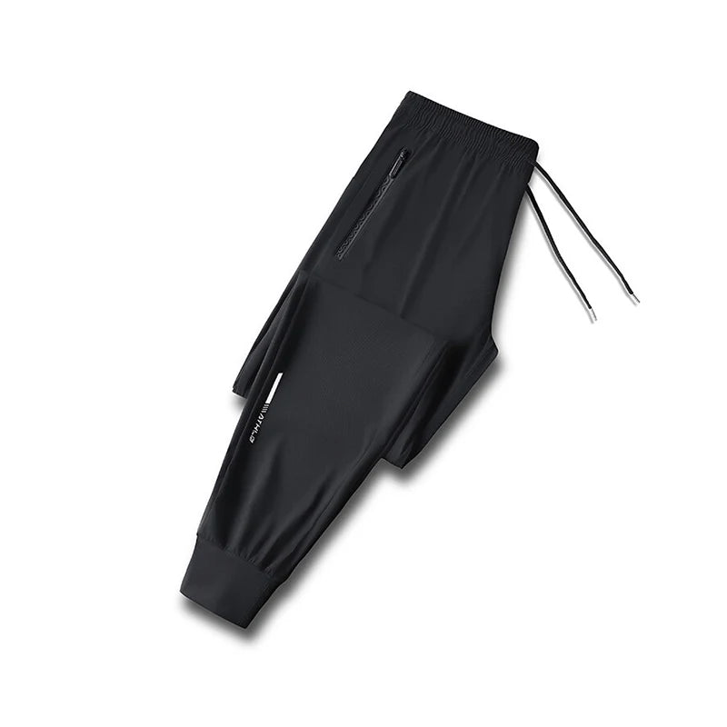 Black men's ice silk performance pants shown flat lay with drawstring detail