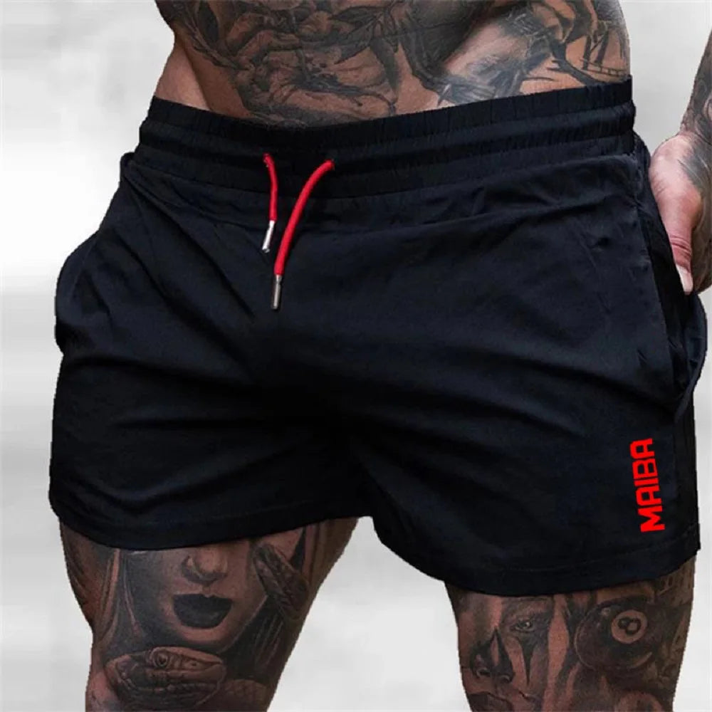 Black men's stretch performance drawstring shorts worn by a model with visible tattoos.