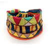 A colorful bohemian stretch cotton headband featuring geometric patterns in shades of red, yellow, blue, and green.