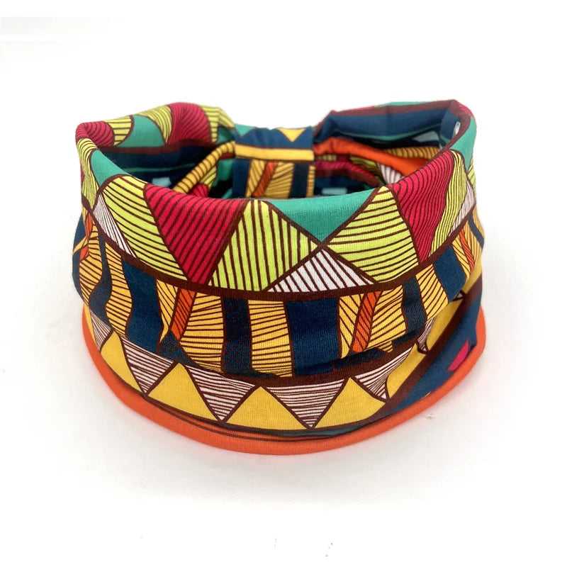 A colorful bohemian stretch cotton headband featuring geometric patterns in shades of red, yellow, blue, and green.