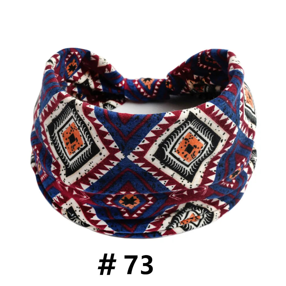 A patterned boho cotton turban headband featuring geometric designs in navy, maroon, and white.