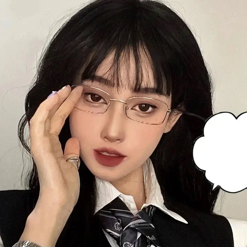 A close-up photo of a woman wearing retro square frame eyeglasses with dark hair and a collared shirt.