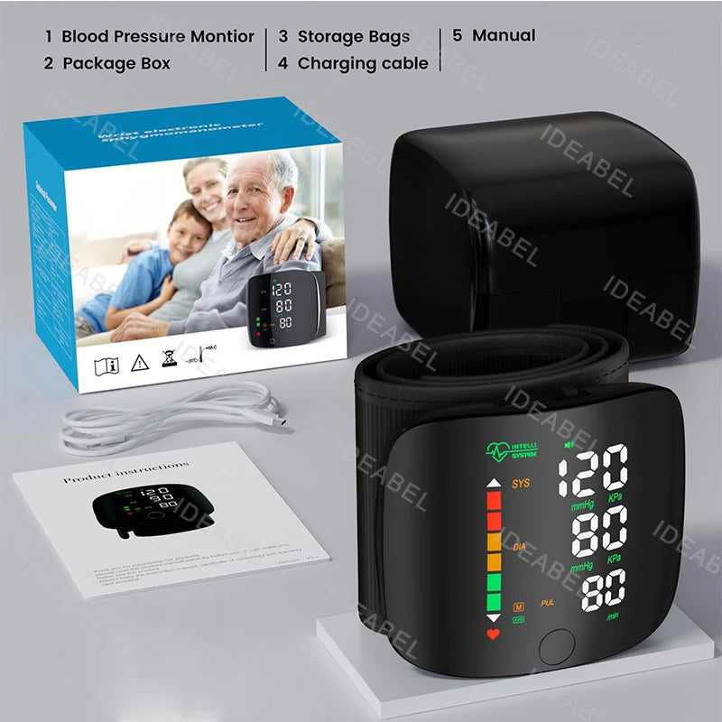 A black digital wrist blood pressure monitor device shown with its box, accessories, and manual.