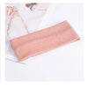 Three knitted headbands in olive green, pink, and red displayed on a white background.